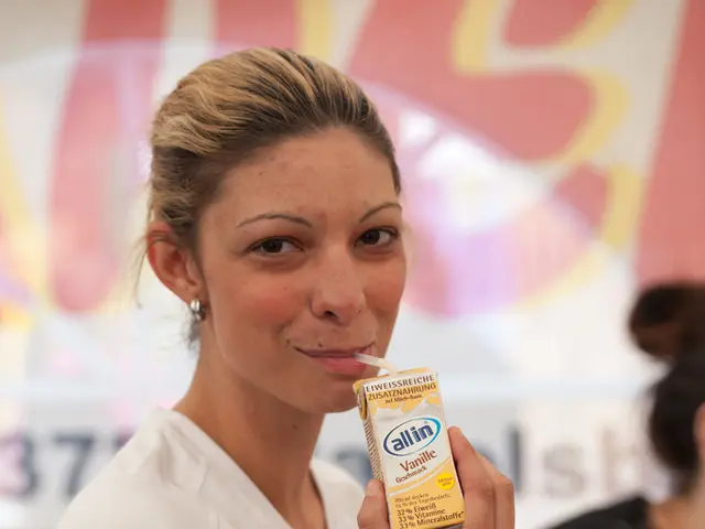 In this image there are two women's in which a woman wearing white T-shirt is drinking a milkshake.