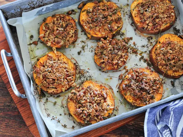 In the image there are cooked food items in a tray and the tray is kept on a wooden table.