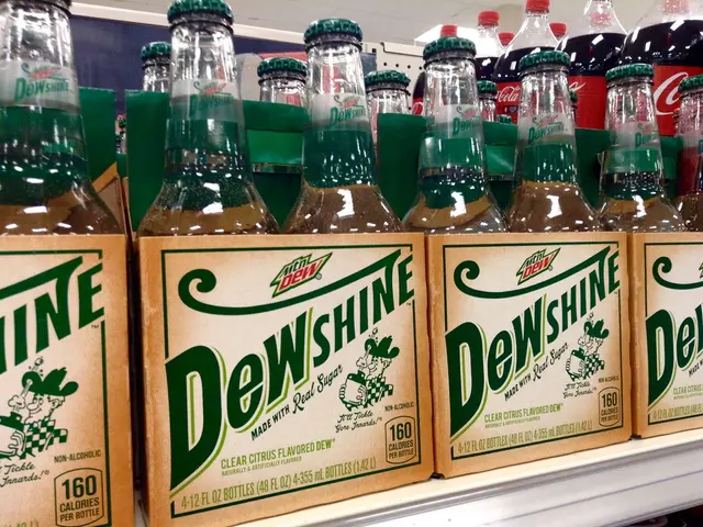 In the image there are drinks which are placed in the boxes. In the background there is a wall.