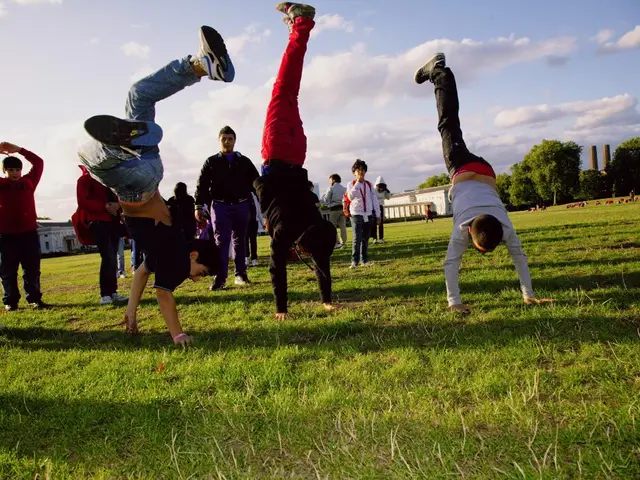 In this image there are a few people standing and few are doing exercise on the surface of the...