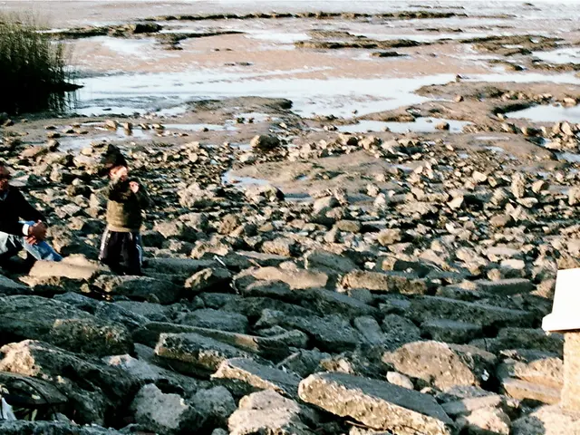 Here we can see two persons. This is water and there are stones.